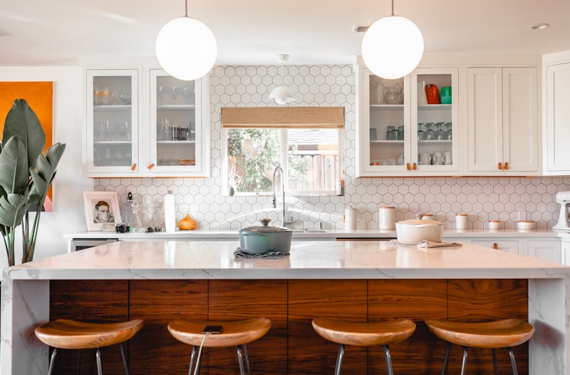Kitchen with hexagon tile backsplash and pendant lighting